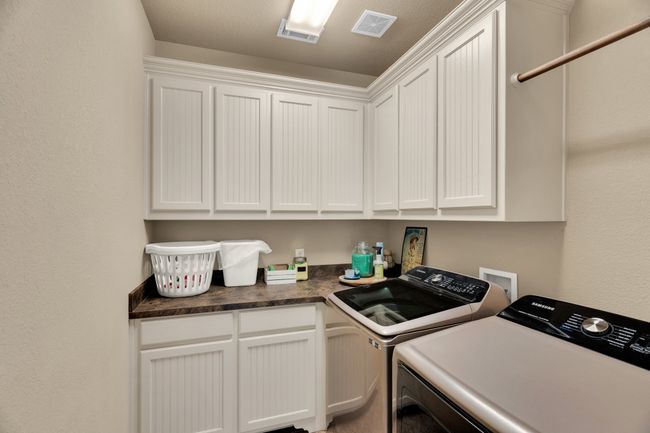 Washroom with washing machine and dryer and cabinet space | Image 18