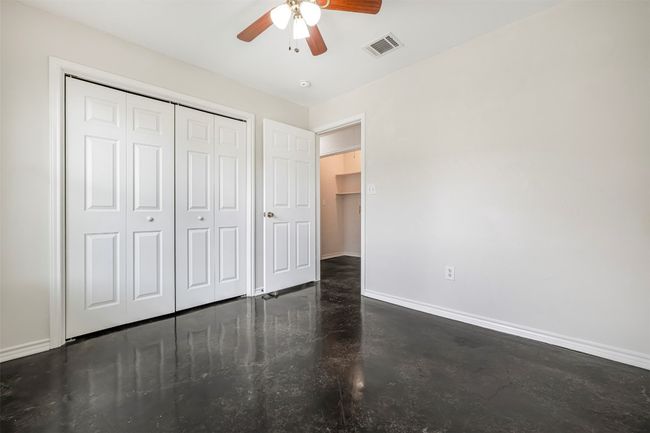 Unfurnished bedroom featuring a closet, finished concrete flooring, and a ceiling fan | Image 22