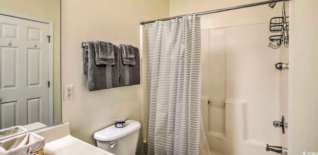 Bathroom featuring vanity and shower / tub combo with curtain | Image 20
