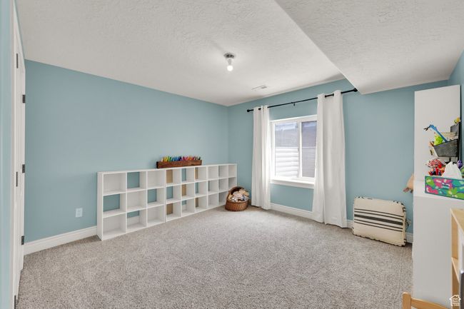 Playroom with carpet flooring and a textured ceiling | Image 18