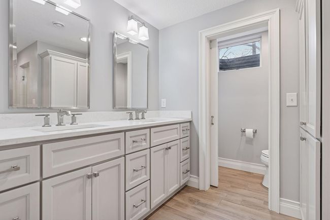 Lower level bathroom has access through the hallway and also adjoins to lower level bedroom. The bathroom has a separate toilet room and large walk in shower with two shower heads. | Image 33