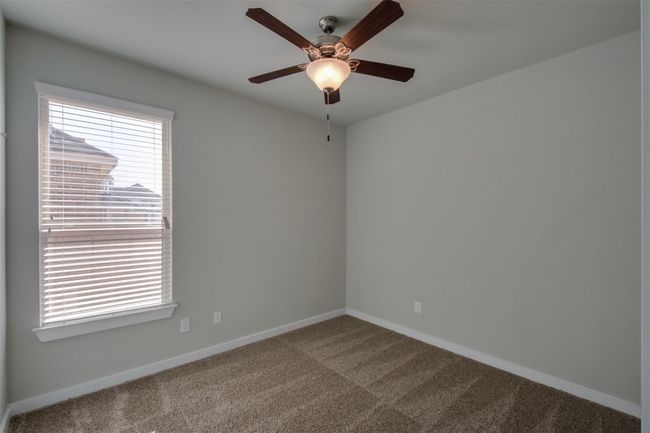 Spare room with a ceiling fan, carpet, and baseboards | Image 12