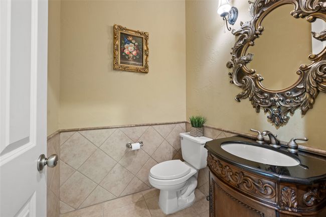 Half bath with vanity, tile patterned floors, wainscoting, and tile walls | Image 19