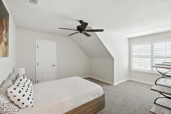 Bedroom featuring carpet, a ceiling fan, and vaulted ceiling | Image 32