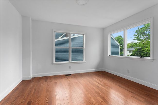Unfurnished room with hardwood / wood-style floors and baseboards | Image 7