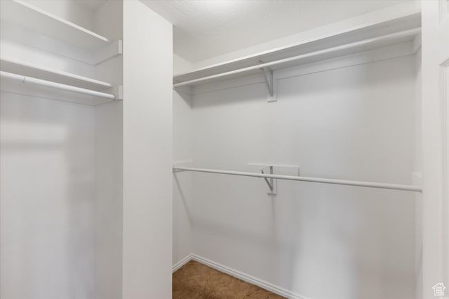 Walk in closet with carpet floors | Image 13