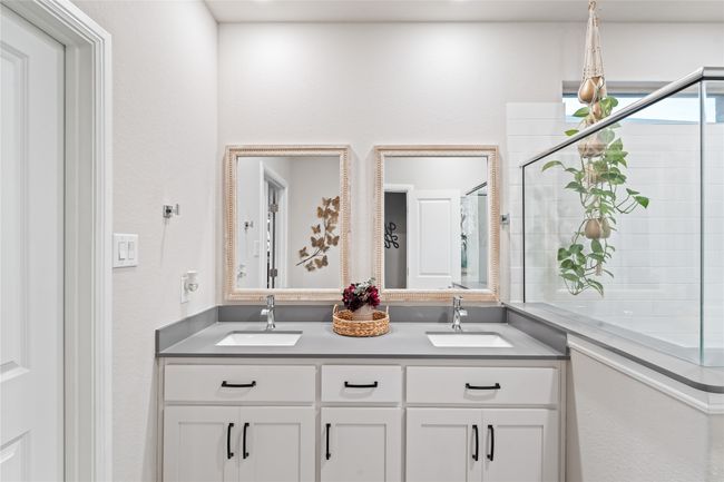 Full bathroom featuring double vanity, a tile shower, and a sink | Image 19