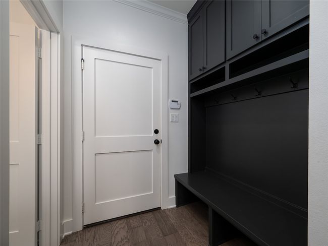 Mudroom featuring dark wood-style floors and crown molding | Image 23