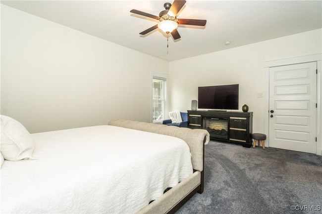 Carpeted bedroom featuring a ceiling fan | Image 19