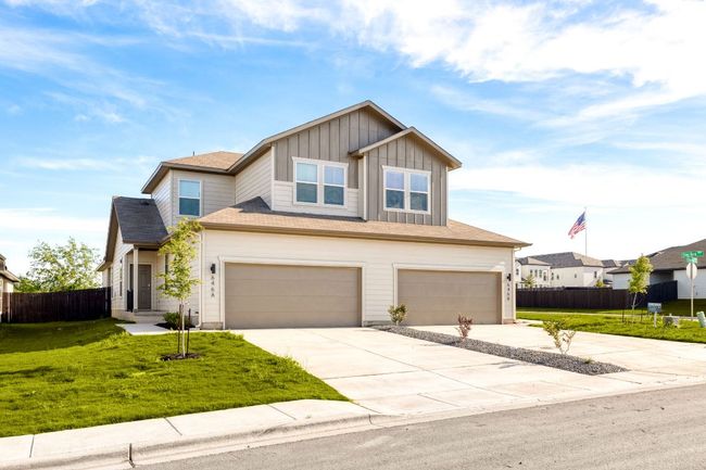 Craftsman house with board and batten siding, a front yard, and fence | Image 5