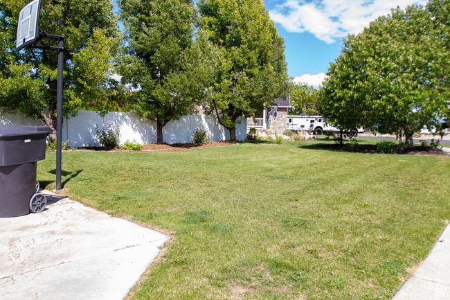View of front side yard with basketball hoop and RV pad | Image 39