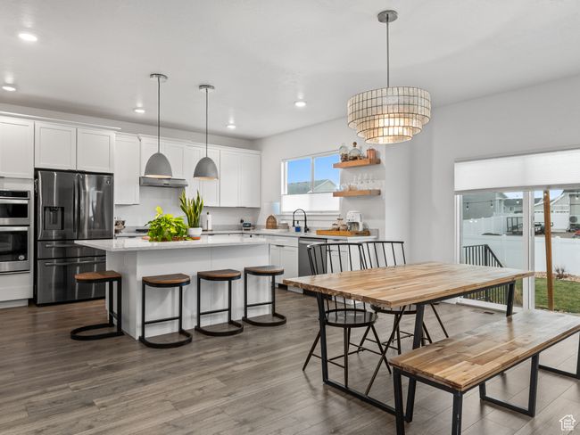 Dining space featuring recessed lighting, dark wood-style flooring, and a chandelier | Image 12