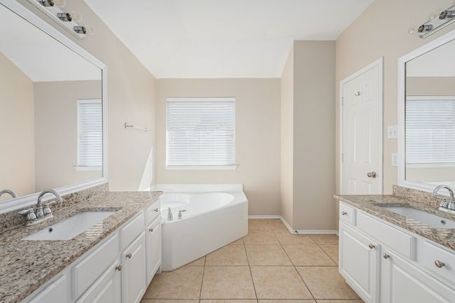 Bathroom featuring two vanities, a garden tub, and tile patterned floors | Image 18