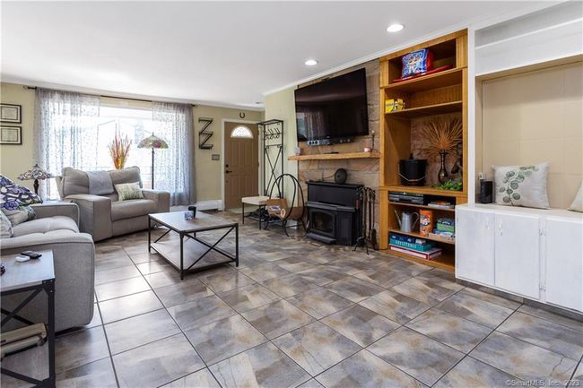 Living Room with Large Picture Window and Functional wood burning stove insert; serviced last year. | Image 6