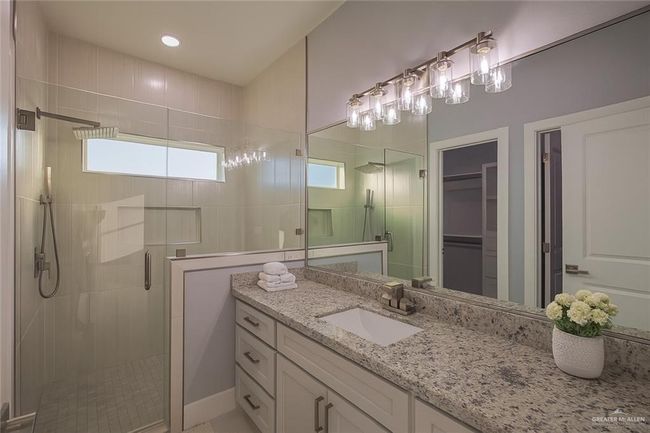 Full bath featuring a stall shower, vanity, and a spacious closet | Image 28