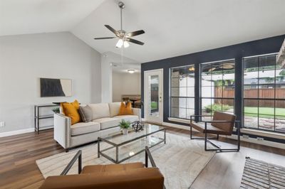 Living room featuring lofted ceiling, dark wood-type flooring, and ceiling fan | Image 3