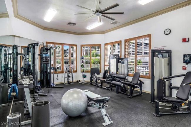 Workout area featuring a ceiling fan, ornamental molding, and baseboards | Image 20