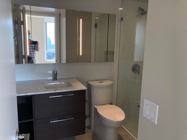 Full bathroom featuring toilet, a shower stall, and vanity | Image 13