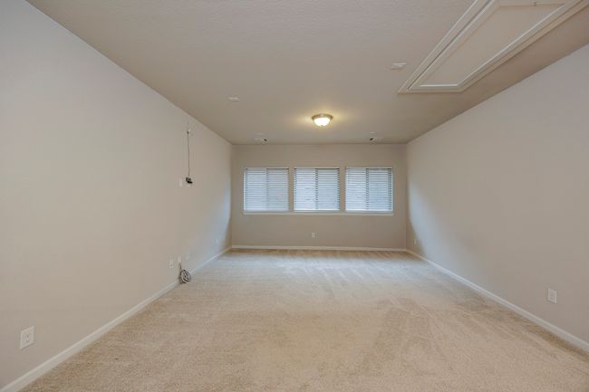 Spare room featuring attic access and light carpet | Image 32