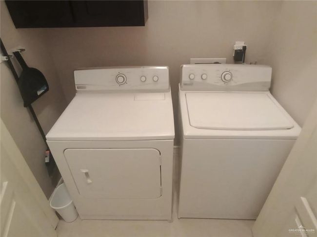 Laundry room featuring washing machine and clothes dryer and cabinet space | Image 5
