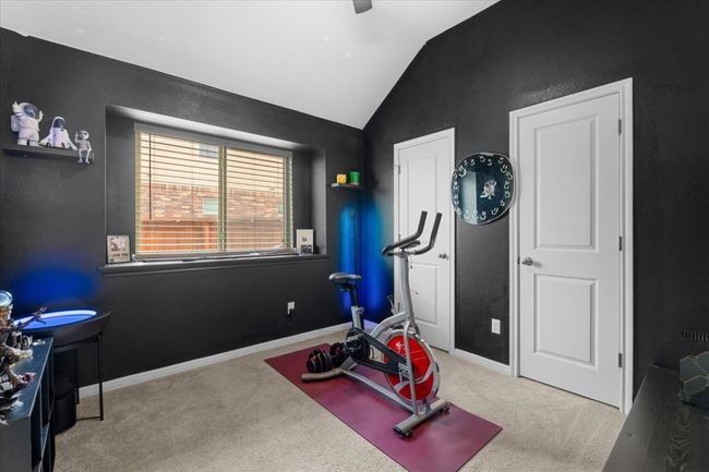 Workout area with carpet flooring, vaulted ceiling, and baseboards | Image 26