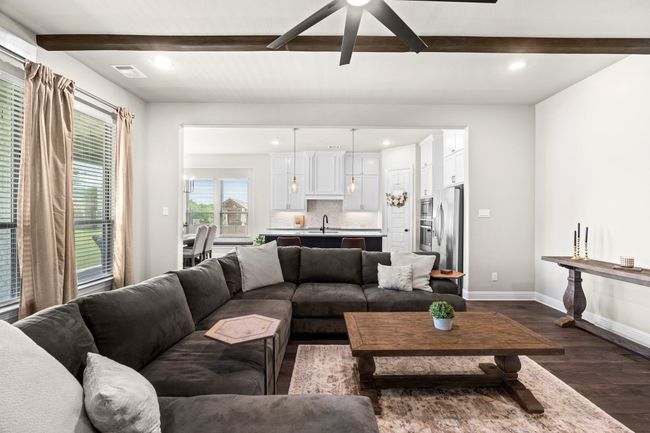 Living area with dark wood-style floors, beamed ceiling, recessed lighting, and a ceiling fan | Image 4