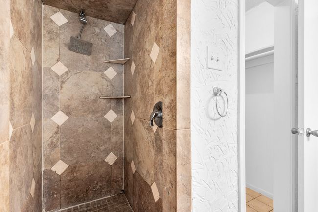 Full bathroom with tile patterned floors and tiled shower | Image 22