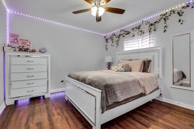 Bedroom with ceiling fan and dark hardwood / wood-style floors | Image 2