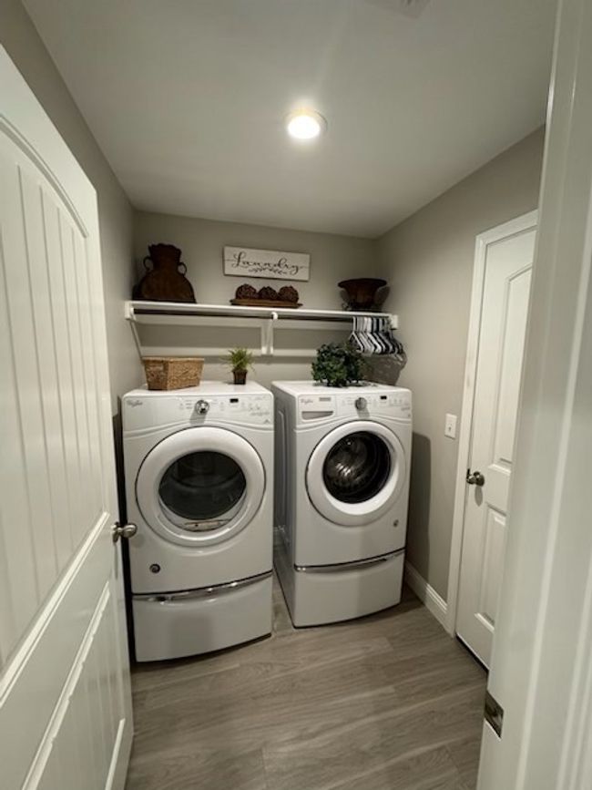 Washroom featuring independent washer and dryer, laundry area, wood finished floors, and recessed lighting | Image 9