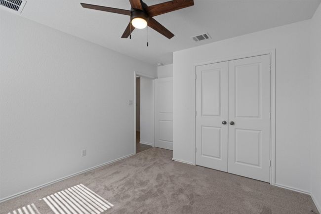 Unfurnished bedroom featuring carpet floors, a closet, and ceiling fan | Image 21