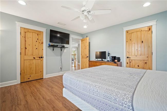 Bedroom featuring baseboards, wood finished floors, recessed lighting, and a ceiling fan | Image 20