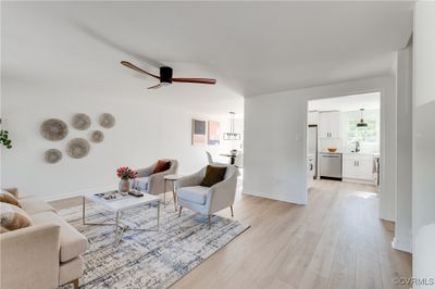 Living room featuring sink, light wood-type flooring, and ceiling fan | Image 3