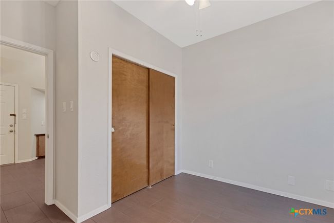 Bedroom showing closet and ceiling fan. | Image 11