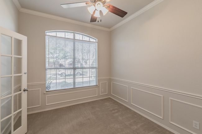 Flex space-Office featuring crown molding, ceiling fan, french doors, and a decorative wall | Image 19