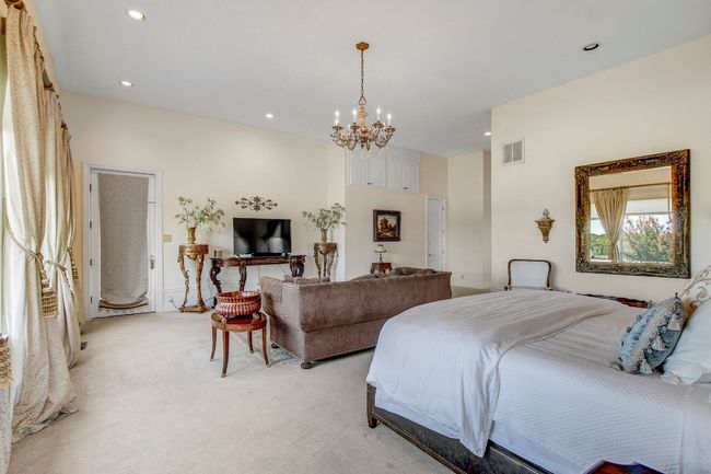 Bedroom with a chandelier, light carpet, and recessed lighting | Image 20