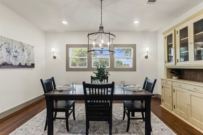 Dining area featuring a chandelier, dark wood finished floors, recessed lighting, and baseboards | Image 12