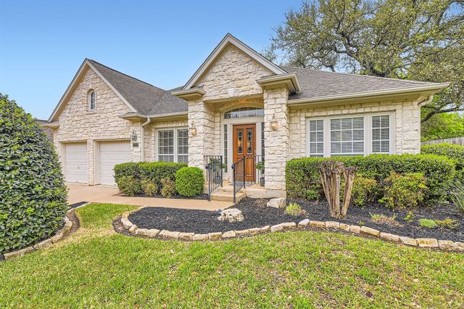 Covered front porch entry with decorative black iron railing | Image 4