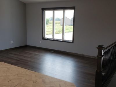 Front facing Livingroom with 3 wide casement window. There's a vaulted ceiling in the LR/DR/Kitchen. | Image 3