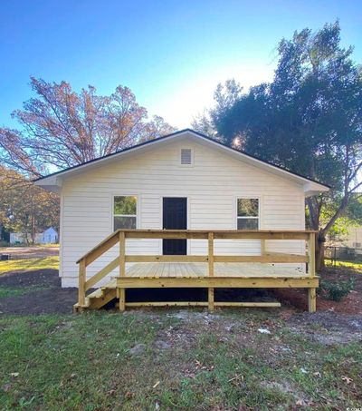 Back of house with a yard and a deck | Image 2