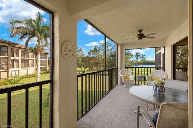 Sunroom / solarium featuring a water view and ceiling fan | Image 21