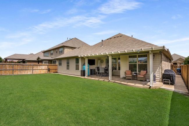 Back of house featuring a shingled roof and a patio area | Image 22