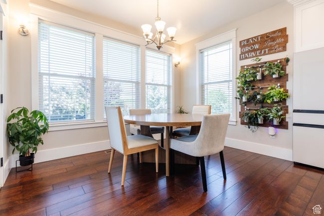 Dining space with a chandelier, healthy amount of natural light, and dark wood finished floors | Image 13