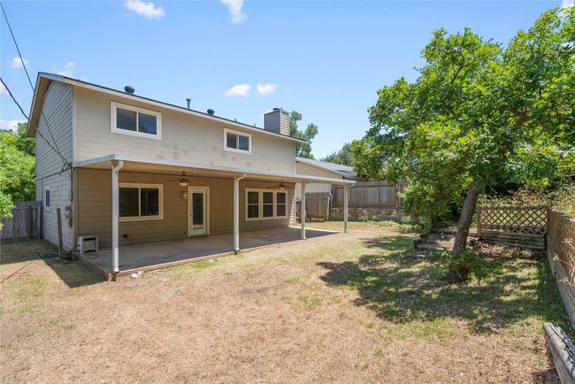 Back of property featuring a ceiling fan, a chimney, and a patio | Image 25
