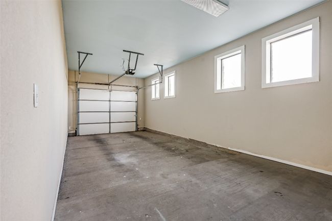 Garage featuring baseboards and a garage door opener | Image 15