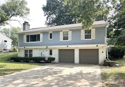 View of front of house featuring a garage and a front lawn | Image 2