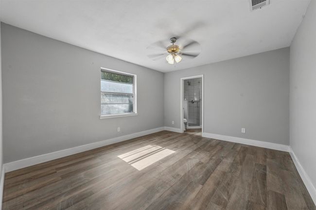 Empty room featuring ceiling fan and dark hardwood / wood-style flooring | Image 23