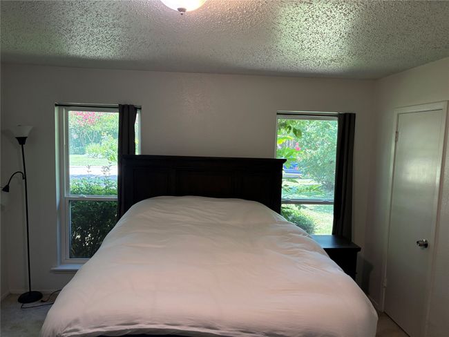 Bedroom featuring carpet and a textured ceiling | Image 7
