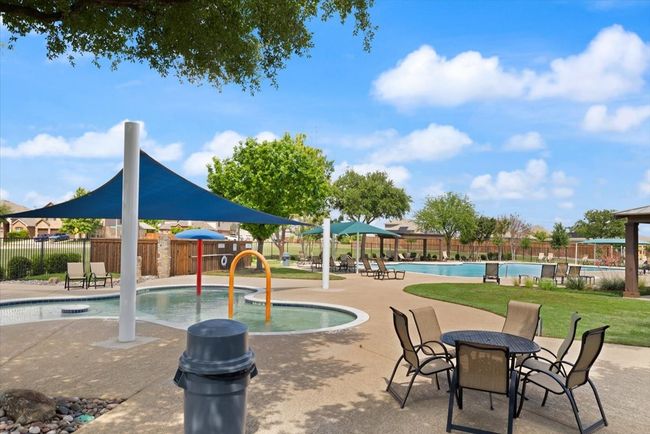 View of the community pool featuring a kids area and a covered sitting area. | Image 4