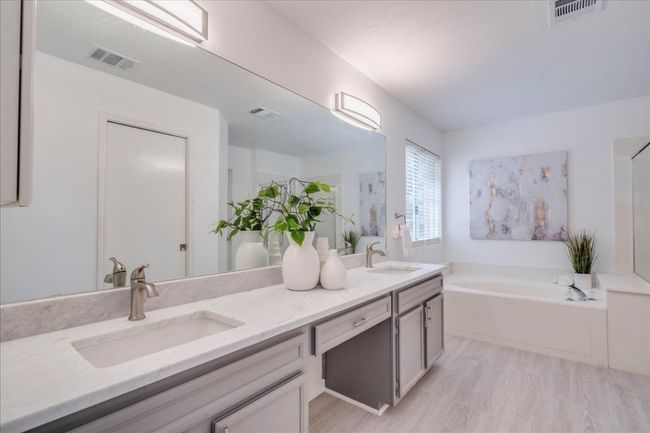 Full bathroom with wood finished floors, double vanity, and a garden tub | Image 18