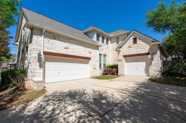 French country style house featuring roof with shingles, concrete driveway, and stone siding | Image 4